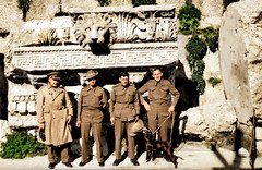 November 1942 - Allied troops in front of one of the great "Temple of Jupiter" frieze and cornice "Lion Head" water spout gargoyles in Baalbek, Syria [now North Lebanon][colourized version
